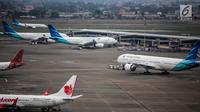 Pesawat maskapai Garuda Indonesia terparkir di areal Bandara Soekarno Hatta, Tangerang, Banten, Kamis (16/5/2019). Pemerintah akhirnya menurunkan tarif batas atas (TBA) tiket pesawat atau angkutan udara sebesar 12-16 persen yang berlaku mulai Kamis hari ini. (Liputan6.com/Faizal Fanani)