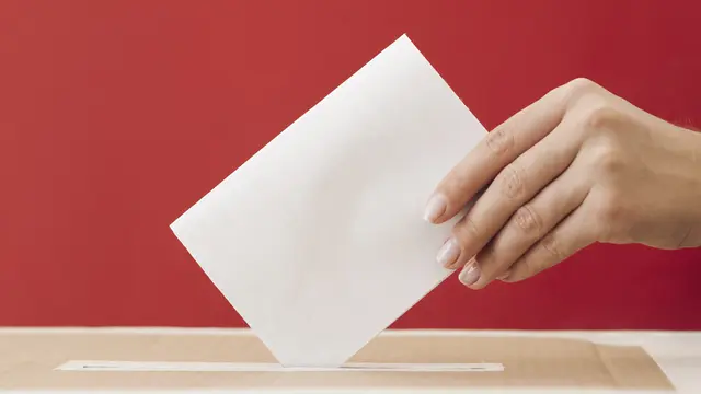 035354600_1603445721-side-view-woman-putting-ballot-box-with-red-background.jpg