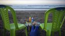 <p>Makanan dan minuman diletakkan di atas meja untuk pasangan saat mereka bersiap untuk berbuka puasa di tepi pantai, di Rabat, Maroko, Sabtu (23/4/2022). Untuk pertama kalinya dalam dua tahun sejak pandemi COVID-19, orang-orang dapat menghidupkan kembali tradisi Ramadhan dengan berkumpul dan berbuka puasa di tempat umum. (AP Photo/Mosa'ab Elshamy)</p>