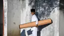 Warga menghadiri kegiatan zikir dan doa memperingati 20 tahun bencana gempa dan tsunami Aceh di salah satu kuburan massal pada Kamis pagi 26 Desember 2024. (CHAIDEER MAHYUDDIN/AFP)