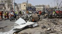 Tim penyelamat di lokasi pemboman di Mogadishu, Somalia (13/2/2021). Petugas polisi Abdullahi Aden, mengatakan bom meledak sekitar pukul 09.00 waktu setempat di kawasan yang semestinya steril karena dalam penjagaan ketat petugas. (AP Photo/Farah Abdi Warsameh)
