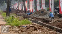 Pekerja menyelesaikan pembuatan saluran air di sekitar trotoar Jalan Gerbang Pemuda Senayan, Jakarta, Kamis (25/8). Pembenahan trotoar di Jalan Gerbang Pemuda dan Asia Afrika, ditargetkan selesai pada akhir 2017. (Liputan6.com/Helmi Fithriansyah)