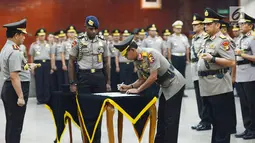 Kapolri Jenderal Tito Karnavian (kiri) menyaksikan Kabareskrim Irjen Pol Idham Azis menandatangani dokumen saat sertijab di Jakarta, Kamis (24/1). Tito memimpin langsung sertijab 17 perwira tinggi Polri. (Merdeka.com/Imam Buhori)