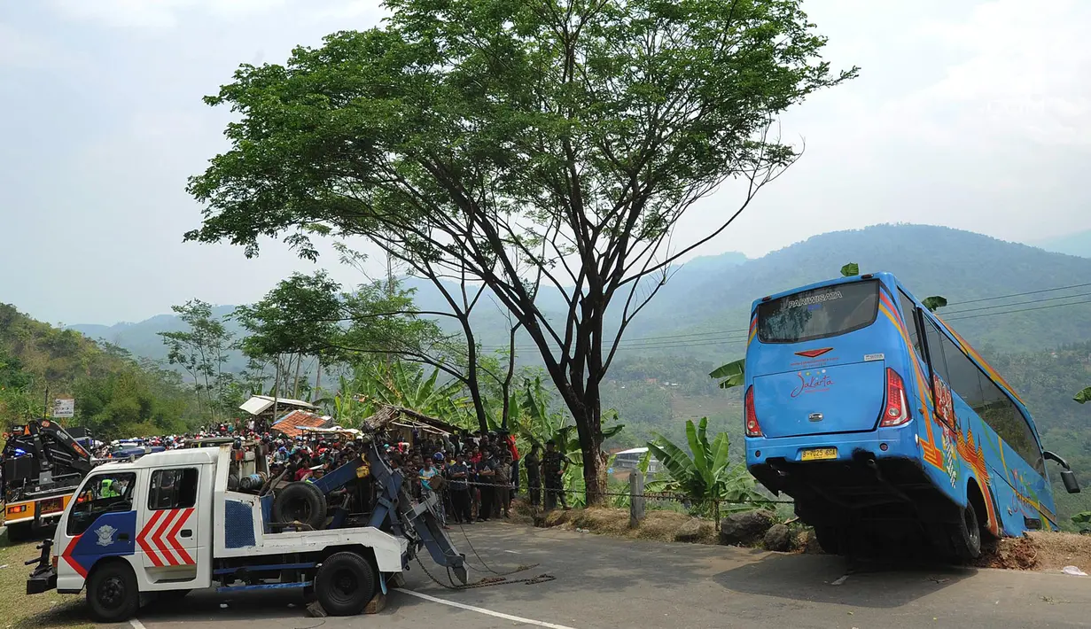 Upaya evakuasi bangkai bus maut Jakarta Wisata Transport yang masuk jurang di jalur alternatif Cikidang, Sukabumi, Jawa Barat, Minggu (9/9). Bus membawa rombongan yang ingin berwisata ke Bravo Adventure Camp Kampung Bantar Selang (Merdeka.com/Arie Basuki)