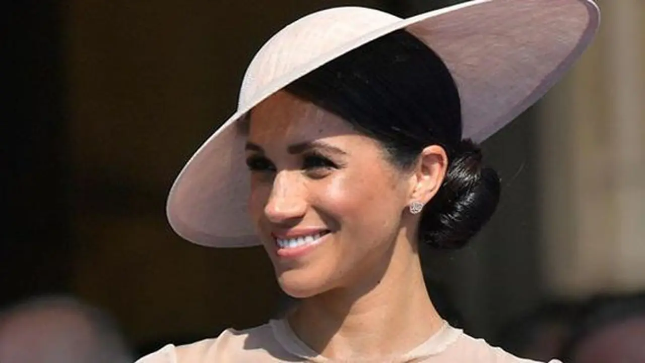 Duchess of Sussex, Meghan Markle menghadiri pesta kebun Istana Buckingham di London, Selasa (22/5). Meghan Markle mulai menunjukkan statement look dirinya dan menampilkan fashion ala kerajaan Inggris. (Dominic Lipinski/Pool Photo via AP)