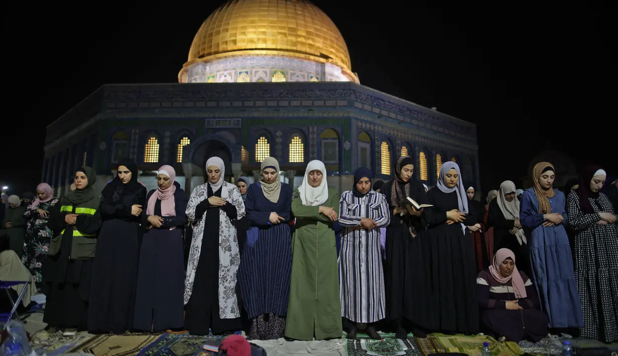 Muslim Palestina menjalani ibadah salat saat memburu malam Lailatul Qadar di luar Kubah Batu (Dome of the Rock) di kompleks Masjid Al-Aqsa di Yerusalem (8/5/2021). (AFP/Ahmad Gharabli)