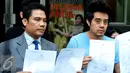 Martin Carter dan kuasa hukumnya menunjukkan surat usai keluar dari Sentra Pelayanan Kepolisian, Polda Metro Jaya, Jakarta, Rabu (19/8/2015). Ia melaporkan sejumlah penyanyi terkait pemutaran lagunya tanpa izin. (Liputan6.com/Panji Diksana)