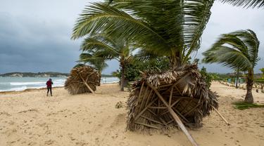 Payung rusak tergeletak di pantai, diterjang Badai Fiona di Punta Cana, Republik Dominika (19/9/2022). Badai Fiona luluh lantakkan Republik Dominika dan Puerto Riko pada Senin (19/9) malam waktu setempat hingga menewaskan sedikitnya 3 orang. (AP Photo/Ricardo Hernandez)