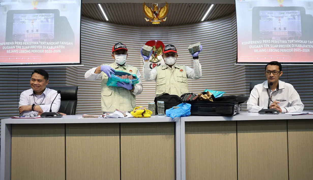 Deputi Penindakan dan Eksekusi KPK, Asep Guntur Rahayu, merinci uang yang disita yakni sebesar Rp756,8 juta. Adapun sebesar Rp309,2 juta berasal dari mobil Kepala Dinas PUPRPKP Harry Eko Purnomo (HEP). Sedangkan  Rp357,6 juta ditemukan dalam tas hitam di rumah tersangka lainnya. Tampak dalam foto, Deputi Penindakan dan Eksekusi Komisi Pemberantasan Korupsi (KPK), Asep Guntur Rahayu (kiri) bersama Juru Bicara KPK Budi Prasetyo (paling kanan) menyaksikan barang bukti Operasi Tangkap Tangan (OTT) dugaan tindak pidana korupsi suap ijon proyek di lingkungan Pemerintah Kabupaten Rejang Lebong Provinsi Bengkulu tahun 2025-2026 di Gedung Merah Putih KPK, Jakarta, Rabu (11/3/2026). (merdeka.com/Arie Basuki)