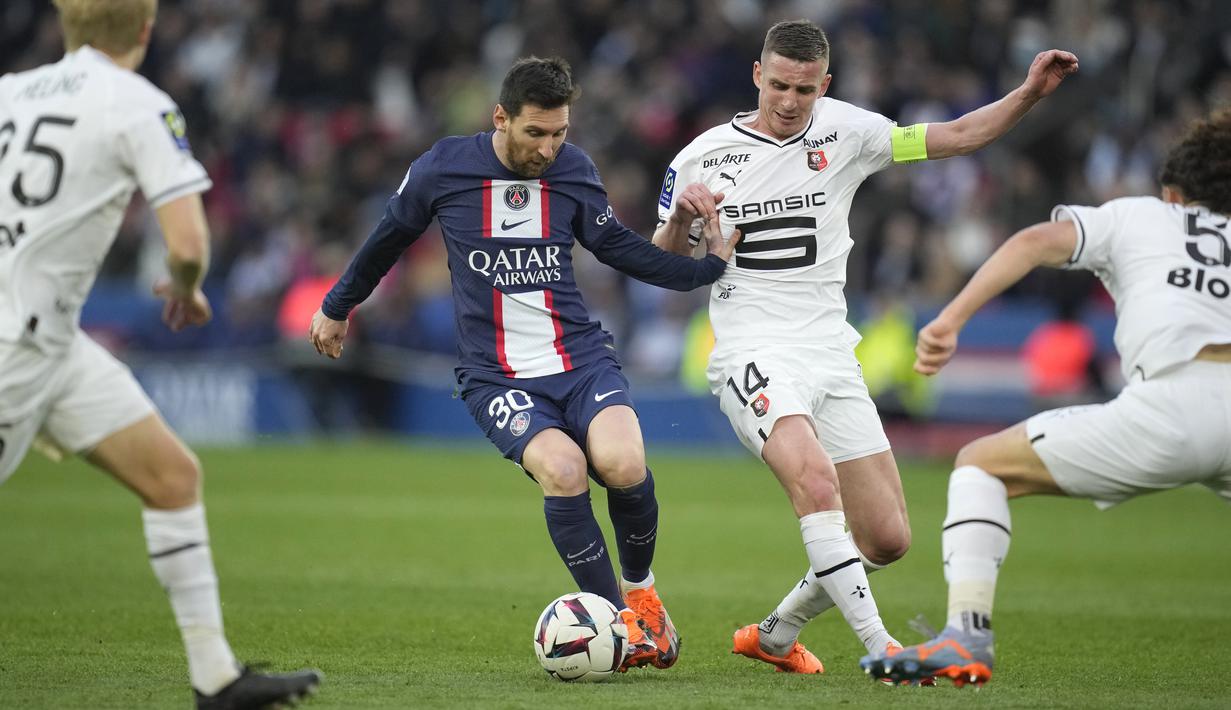 Pemain Paris Saint-Germain (PSG), Lionel Messi, berusaha melewati penjagaan ketat pemain Stade Rennes pada laga Liga Prancis di Stadion Parc des Princes, Minggu (19/3/2023). (AP Photo/Christophe Ena)