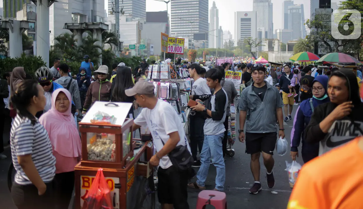 Pedagang kaki lima (PKL) berjualan di jalan saat car free day (CFD) di kawasan Bundaran HI, Jakarta, Minggu (6/10/2019). Kurangnya pengawasan petugas menyebabkan banyak PKL yang berjualan tidak pada tempat yang telah disediakan oleh Pemprov DKI Jakarta. (Liputan6.com/Faizal Fanani)