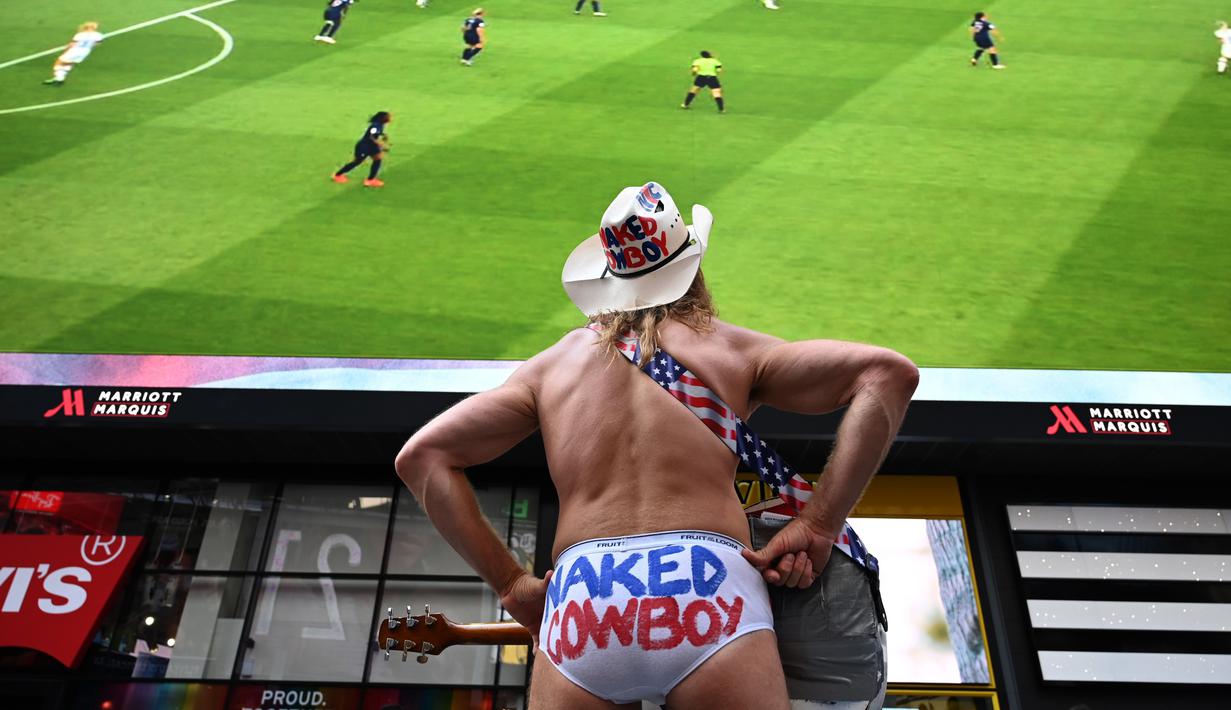 US actor the "Naked Cowboy" watches the 2019 Women's World Cup quarter-final football match between France and the United States on a big screen in Times Square in New York on June 28, 2019. (Photo by TIMOTHY A. CLARY / AFP)