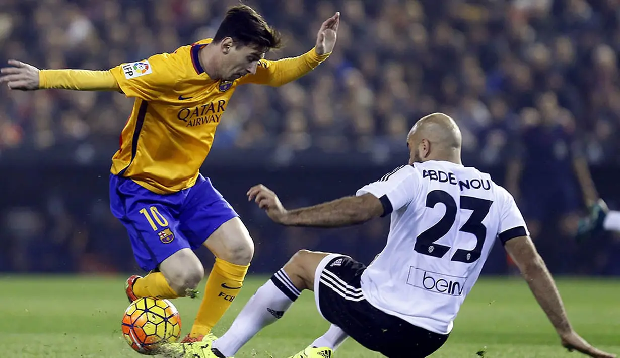 Bintang Barcelona, Lionel Messi, berusaha melewati hadangan pemain Valencia, Aymen Abdennour, pada laga La Liga Spanyol di Stadion Mestalla, Spanyol, Sabtu (5/12/2015). (EPA/Kai Foersterling)