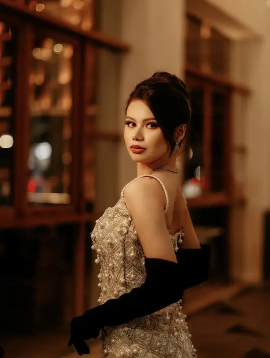 Kali ini, bergaya 20's dres dengan taburan mutiara serta sarung tangan beludru membuat tampilannya tuai pujian. [Foto: Instagram/ Fabienne Nicole]