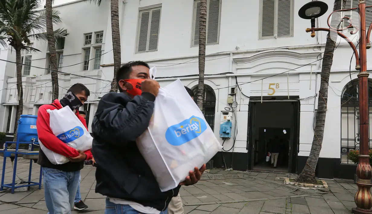 Warga menerima paket sembako usai acara kegiatan CSR Tiket Ramadan di Kota Tua Fatahillah, Jakarta, Kamis (06/05/2021). Kegiatan sosial bertajuk Beramal Bersama Teman menjelang Idul Fitri juga membagikan kepada petugas keamanan dan kebersihan, komunitas seniman. (Liputan6.com/Fery Pradolo)