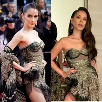 Cinta Laura dan Alyssa Daguise kedapatan memakai gaun yang sama di event berbeda. Gaun rancangan Tex Saverio tersebut adalah terinspirasi dari ratu pantai selatan alias Nyi Roro Kidul. [@hairdoby_ell/@claurakiehl]