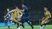 Gelandang Arema FC, Adam Alis, mencoba melewati adangan bek Persib Bandung, Vladimir Vujovic, dalam laga di Stadion Kanjuruhan, Kabupaten Malang, Sabtu (12/8/2017). (Bola.com/Iwan Setiawan)