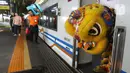 Barongsai usai beraksi di dalam salah satu rangkaian gerbong KA Bima di Stasiun Gambir, Jakarta, Sabtu (25/1/2020). PT Kereta Api Indonesia (Persero) Daop 1 Jakarta mengadakan pertunjukkan Barongsai itu dalam rangka memeriahkan perayaan Tahun Baru Imlek 2571/2020. (Liputan6.com/Herman Zakharia)