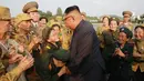 Seorang veteran perang wanita mencium tangan Pemimpin Korea Utara Kim Jong-un selama acara Konferensi Veteran Perang Nasional ke-5 di pemakaman perang Martyrs Cemetery di Pyongyang (27/7). (KCNA/via AP Photo)