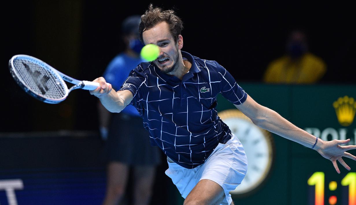 Petenis Rusia, Daniil Medvedev, mengembalikan bola ke arah lawannya, petenis Austria, Dominic Thiem dalam partai final tunggal putra Turnamen Tenis ATP Finals 2020 di O2 Arena, London, Inggris, Minggu (22/11/2020). Daniil Medvedev menang dengan skor 4-6, 7-6 (2), 6-4. (AFP/Glyn Kirk)