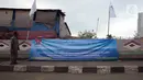 Warga melihat spanduk penolakan PP Nomor 85 Tahun 2021 KKP terkait tarif atas jenis PNBP di Pelabuhan Muara Angke, Jakarta, Sabtu (9/10/2021). Ratusan nelayan memilih tidak melaut untuk memprotes terbitnya PP Nomor 85 Tahun 2021 KKP terkait tarif atas jenis PNBP. (merdeka.com/Imam Buhori)