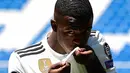 Penyerang baru Real Madrid, Vinicius Junior mencium logo klub selama presentasi resmi dirinya di Stadion Santiago Bernabeu, Madrid (20/7). Vinicius sudah direkrut Madrid pada bursa transfer musim panas 2017. (AFP Photo/Pierre-Philippe Marcou)