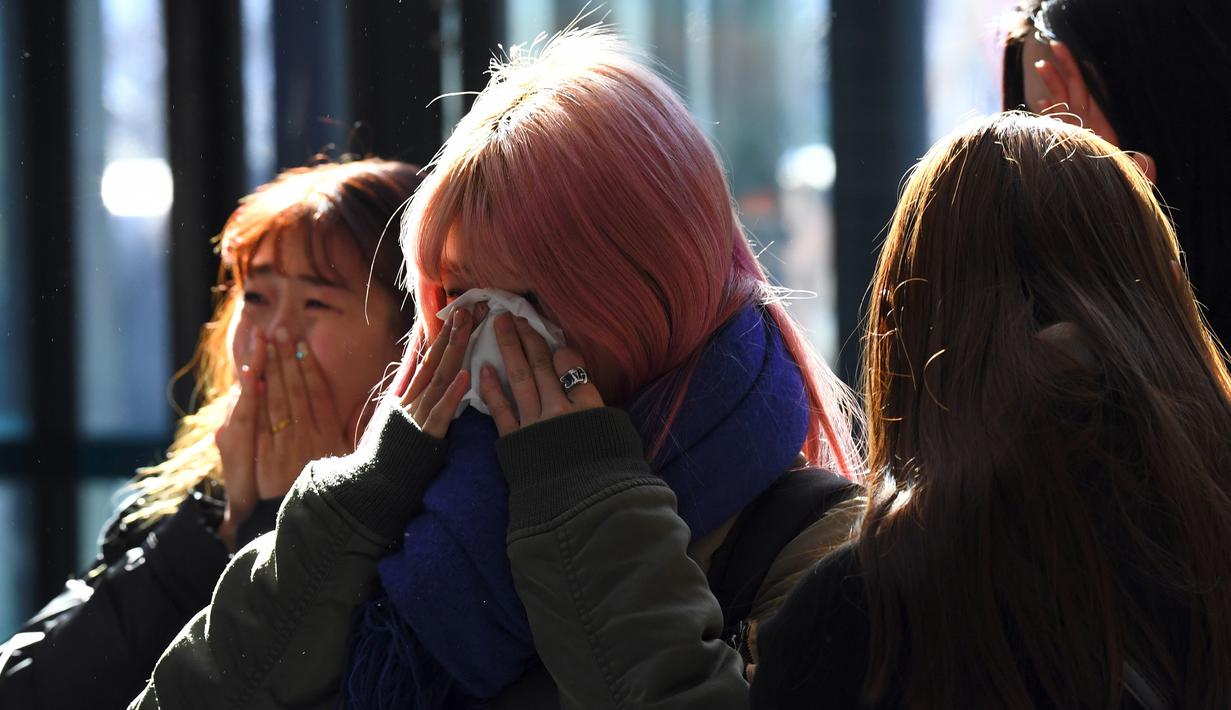 Kesedihan sejumlah fans saat datang memberikan penghormatan kepada Jonghyun SHINee di rumah duka Seoul Asan Hospital, Selasa (19/12). Ratuhan fans tampak memenuhi tempat persemayaman Jonghyun SHINee dengan isakan tangis. (JUNG Yeon-Je / AFP)