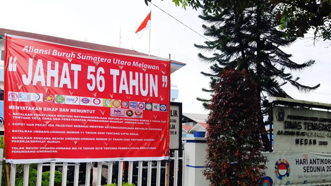 Baliho bertuliskan "Menolak JAHAT 56 Tahun"