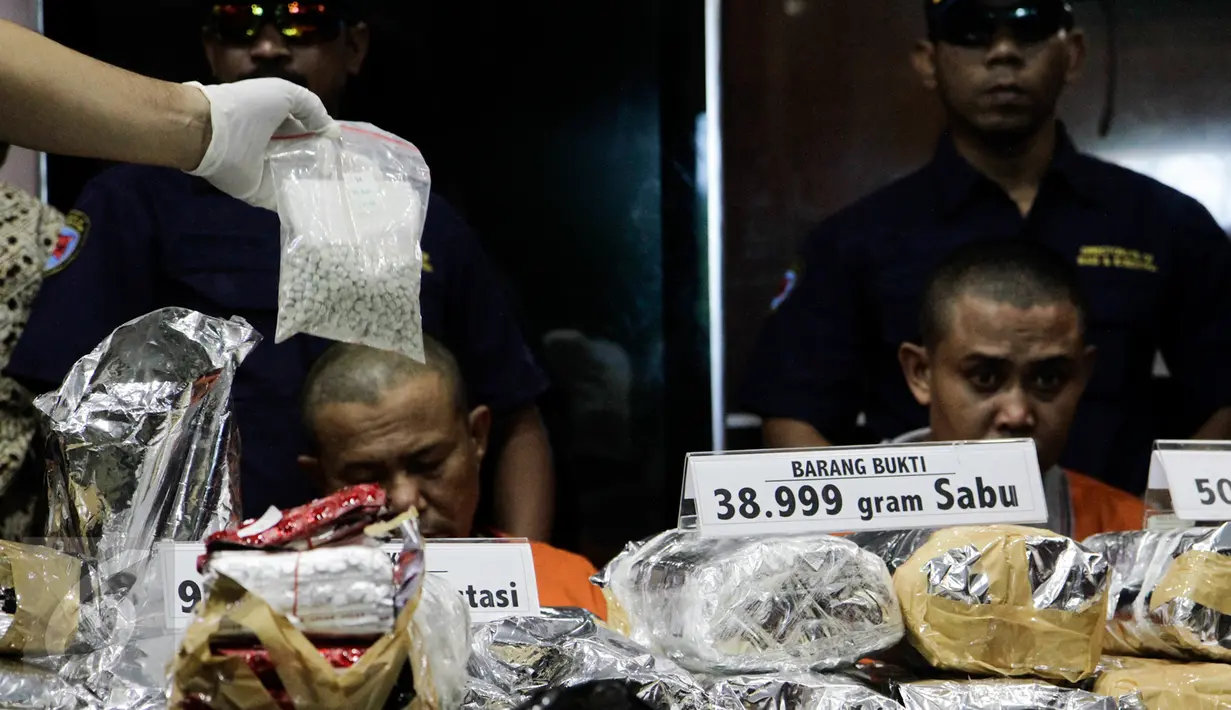 Petugas memperlihatkan barang bukti saat rilis sindikat peredaran narkotika di Gedung BNN, Jakarta, Jumat (28/10). Sebanyak 50.000 butir H5, 39 kg sabu dan 98.960 butir ekstasi berhasil diamankan dari tiga tersangka. (Liputan6.com/Yoppy Renato)