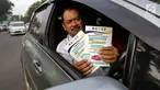 Pengendara mobil menunjukkan selebaran sosialisasi pemberlakuan sistem ganjil genap di pintu masuk Gardu Tol Cibubur 2, Jakarta, Senin (16/4). Kebijakan ini diterapkan untuk mengurai kemacetan di ruas Tol Jagorawi. (Liputan6.com/Faizal Fanani)