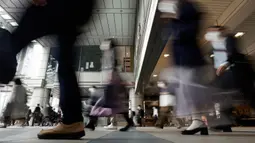 Sebuah lorong stasiun dipenuhi oleh para penumpang yang menggunakan masker selama jam sibuk di Tokyo, Selasa (26/5/2020). Perdana Menteri Jepang Shinzo Abe mencabut keadaan darurat pandemi virus corona di Tokyo dan empat wilayah lainnya pada Senin (25/5). (AP Photo/Eugene Hoshiko)