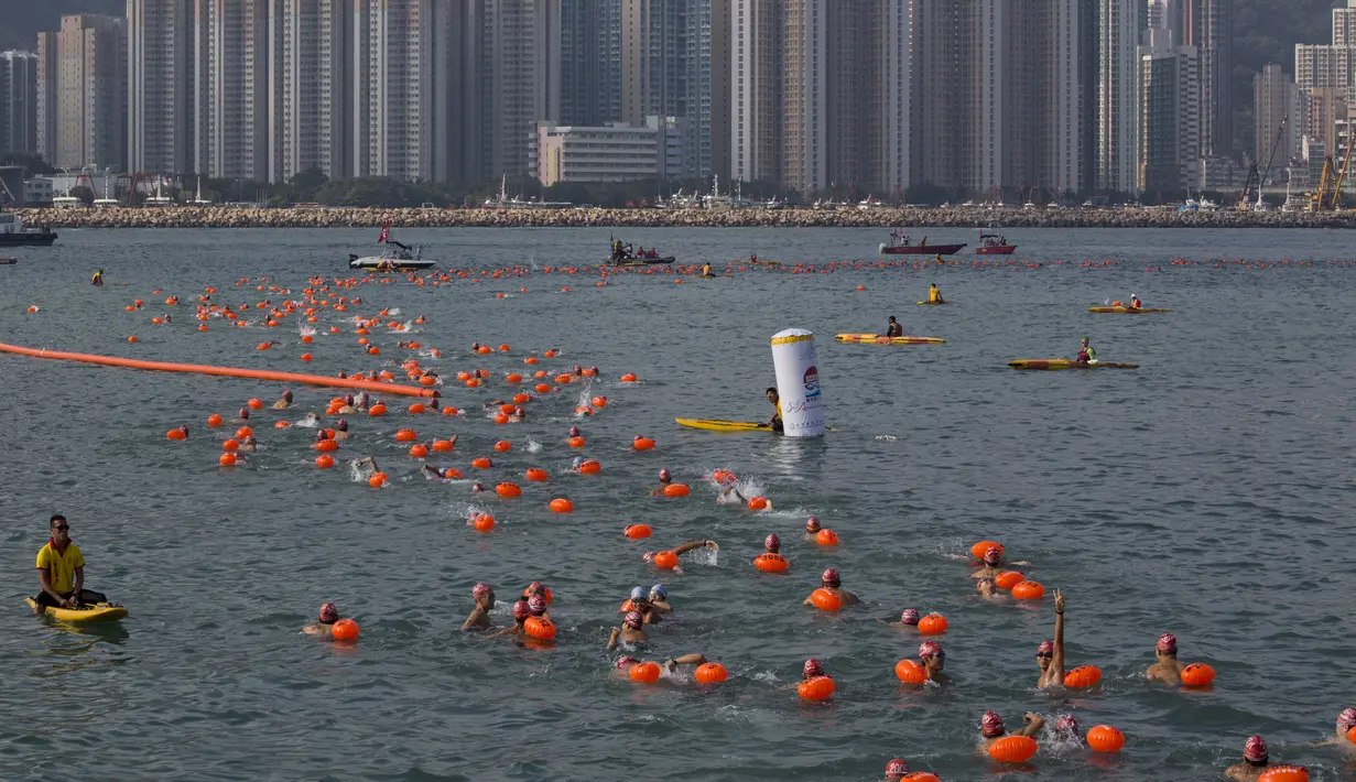 Perenang berkompetisi dalam lomba renang lintas pelabuhan di Hong Kong, Minggu (18/10). 2.500 orang ambil bagian dalam menembus jarak lintasan laut sejauh 1,5 km dari Sam Ka Tsuen Public Pier ke Quarry Bay Park Public Pier. (REUTERS/Tyrone Siu)