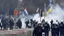 Polisi menghadapi pengunjuk rasa selama demonstrasi menentang tindakan COVID-19 di Brussels, Minggu (23/1/2022). Beberapa hari terakhir di Belgia angka jumlah orang yang terinfeksi varian omicron telah memuncak, mencapai jumlah rekor baru setiap hari. (AP Photo/Geert Vanden Wijngaert)