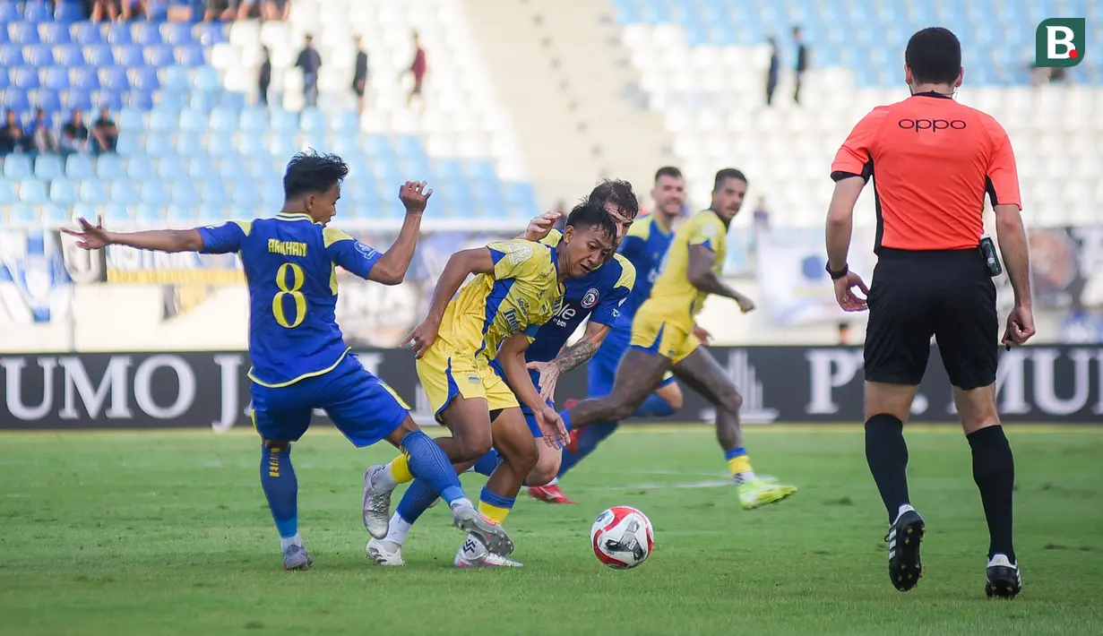 Pemain Persib Bandung, Beckham Putra, berusaha melewati pemain Arema FC pada laga pekan keenam BRI Super League 2025/2026 di Stadion Kanjuruhan, Kabupaten Malang, Senin (22/9/2025) sore WIB. (Bola.com/Iwan Setiawan)