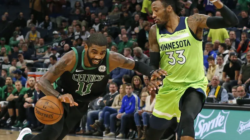 Point guard Celtics Kyrie Irving menerobos pertahanan Timberwolves di laga NBA