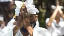 Seorang pria yang memakai masker bersembahyang saat Hari Raya Galungan di sebuah pura di Bali, Rabu (14/4/2021). Perayaan Hari Raya Galungan yang merupakan hari kemenangan kebenaran (Dharma) atas kejahatan (Adharma) itu diikuti umat Hindu dengan menerapkan protokol kesehatan. (AP/Firdia Lisnawati)