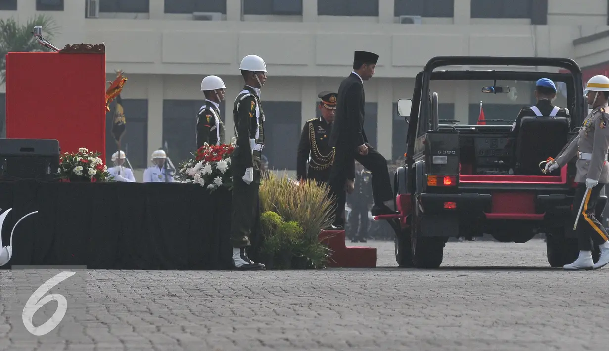 Presiden Joko Widodo menaiki mobil untuk memeriksa pasukan dalam upacara HUT Bhayangkara Polri ke-69 di Jakarta, Rabu (1/7/15). Upacara HUT Bhayangkara Polri ke-69 dihadiri Presiden Joko Widodo sebagai inspektur upacara. (Liputan6.com/Herman Zakharia)