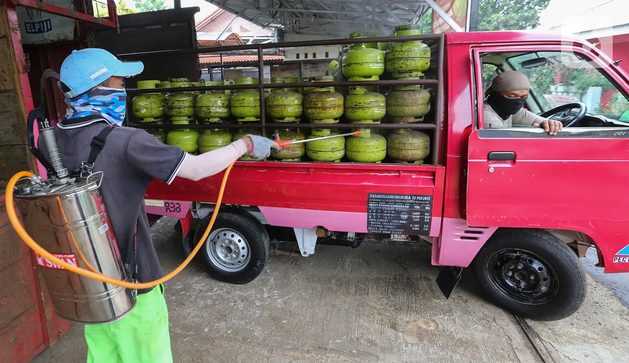 Karyawan menyemprotkan cairan disinfektan ke tabung gas ukuran 3 kg di Agen LPG 3 kg, Bojongsari, Depok, Senin (4/5/2020). Selain penyemprotan, sejumlah karyawan agen juga dibekali dengan masker dan sarung tangan untuk menghindari penyebaran Covid-19. (Liputan6.com/Fery Pradolo)