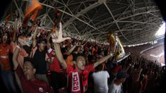 Suporter Persija Jakarta mengangkat replika piala saat merayakan gelar juara Liga 1 di SUGBK, Jakarta, Minggu (09/12). Persija menang 2-1 atas Mitra Kukar. (Bola.com/M Iqbal Ichsan)