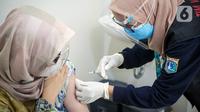 Vaksinator menyuntikkan vaksin COVID-19 dari Pfizer kepada warga di Puskesmas Lebak Bulus, Jakarta, Senin (23/8/2021). Sebanyak 1.560.780 dosis vaksin COVID-19 Pfizer tiba di Indonesia pada 19 Agustus 2021 melalui skema pembelian langsung. (Liputan6.com/Faizal Fanani)