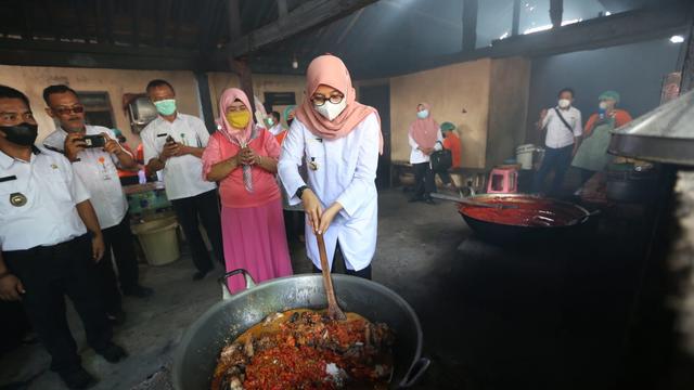 Bupati Banyuwangi Ipuk Fiestiandani  tengah mengaduk ayam pedas rantinem (Istimewa)