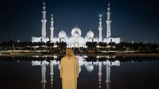 Seorang pria melihat Masjid Agung Sheikh Zayed di Abu Dhabi,  pada tanggal 14 Maret 2025, selama bulan puasa Ramadan. (FADEL SENNA/AFP)