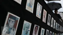 Aktivis JSKK membawa foto korban HAM saat aksi Kamisan ke-467, Jakarta, Kamis (10/11). Bertepatan Hari Pahlawan, JSKK kembali meminta kepada Presiden Jokowi agar segera menuntaskan kasus pelanggaran HAM berat masa lalu. (Liputan6.com/Immanuel Antonius)