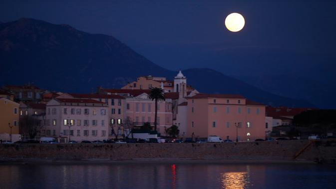 Fenomena super snow moon terlihat di atas Ajaccio, Corsica, Prancis, Selasa (19/2). Super snow moon terjadi karena orbit bulan berada di posisi paling dekat dengan Bumi. (PASCAL POCHARD-CASABIANCA/AFP)