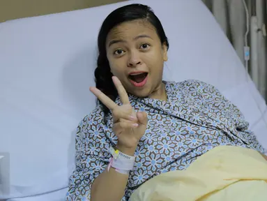 Vokalis Band Kotak Tantri Syalindri Ichlasari tampak ceria usai melahirkan di Rumah Sakit  YPK Mandiri, Jakarta, Minggu (24/4).Anak Tantri Kotak berjenis kelamin perempuan yang lahir pada sabtu (23/4) pukul 21.23 wib. (Liputan6.com/Gempur M Surya)