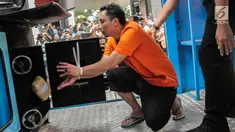 Tersangka memasukkan barang bukti narkoba ke dalam mesin insimilator saat pemusnahan di Bareskrim Mabes Polri, Jakarta, Selasa (9/7/2019). Bareskrim Polri memusnahkan 177,5 Kg sabu dan 30 ribu butir ekstasi yang disita dari jaringan Malaysia-Indonesia. (Liputan6.com/Fazail Fanani)