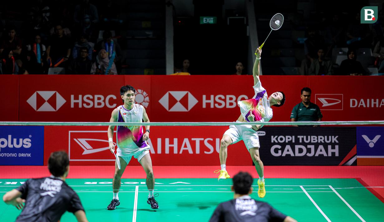 Pebulu tangkis ganda putra Indonesia, Raymond Indra/Nikolaus Joaquin berusaha mengembalikan kok ke arah pasangan Prancis, Eloi Adam/Leo Rossi dalam laga babak 32 besar Indonesia Masters 2026 di Istora, Senayan, Jakarta, Selasa (20/01/2026). (Bola.com/Bagaskara Lazuardi)