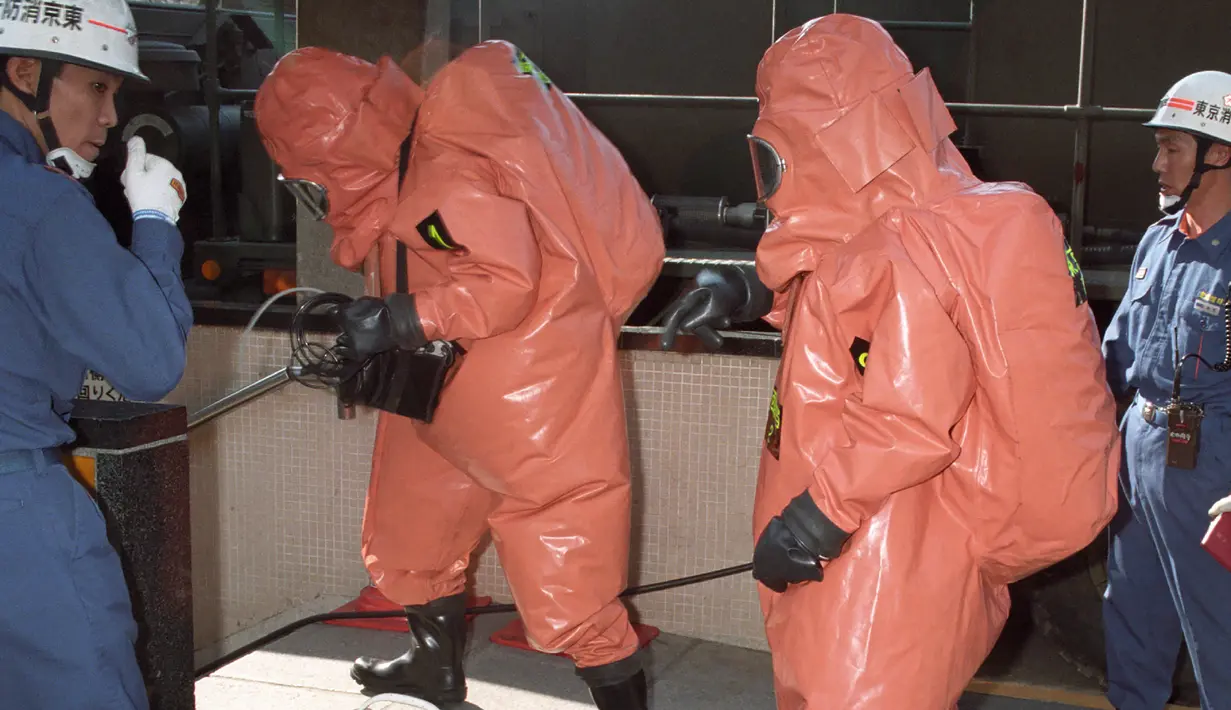 Petugas pemadam kebakaran memeriksa lokasi serangan gas sarin oleh sekte kiamat Aum Shinrikyo di stasiun kereta bawah tanah Tsukiji, Tokyo, Jepang, 20 Maret 1995. Racun itu menyerang korban dalam hitungan detik. (JIJI PRESS/AFP)
