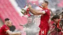 Kapten Liverpool, Jordan Henderson, tampak emosional saat mengagkat trofi Piala FA di Stadion Wembley. (AP/Kirsty Wigglesworth)