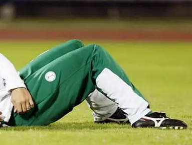 Saudia Arabia's Yasser al-Qahtani lies on the field during a training session in the Omani capital Muscat on January 16, 2009. Saudi Arabia faces Oman tomorrow in the 19th Gulf Cup final. AFP PHOTO/KARIM JAAFAR 